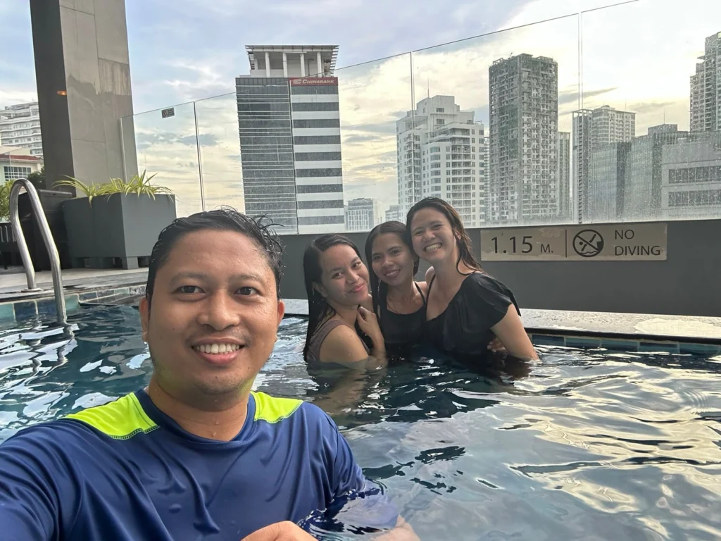 Group photo of a boy and three girls swimming in the pool at Holiday Inn Cebu City